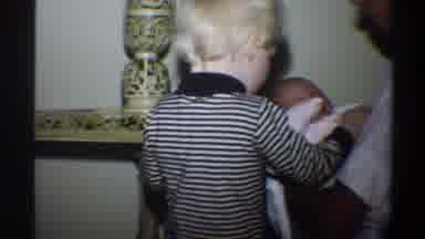 Gainsville Florida USA (1974): Older Child Holding The Hand Of A Baby Being Held