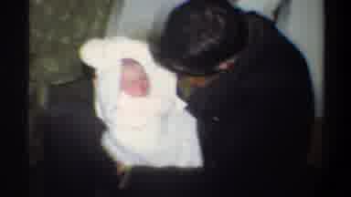Gainsville Florida USA (1974): Man Sideburns Talking To Newborn Baby Bundled In