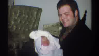 Gainsville Florida USA (1974): A Man Smiles Holding A Small Baby