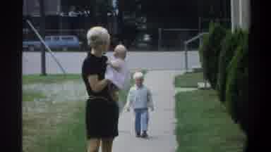 Gainsville Florida USA (1974): Purse Woman And Man In Striped Shirt Going Against