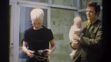 Gainsville Florida USA (1974): Man Carrying Baby Down A Step With Two Women Next