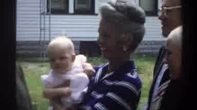 Gainsville Florida USA (1974): An Older Woman Smiles While Holding A Pale Baby