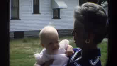 Gainsville Florida USA (1974): Mother With Her Little Girl In A Dress With A House