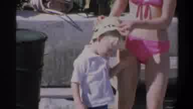 Gainsville Florida USA (1974): Girl In A Pink Bikini With A Child Walking And A