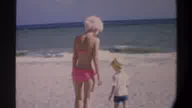 Gainsville Florida USA (1974): Woman In A Bikini On The Beach With A Child Walking