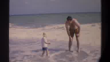 Gainsville Florida USA (1974): A Father And Son Play In The Waves