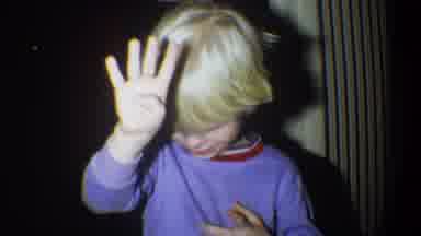 Gainsville Florida USA (1974): A Blonde Boy Holds Up His Hands To Block A Strong