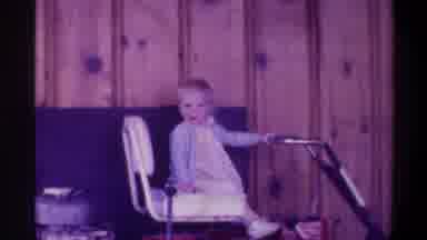 Gainsville Florida USA (1974): Child Wearing Blue And White Sitting On Cart In
