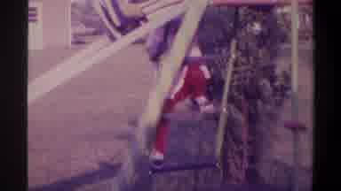 Gainsville Florida USA (1974): Small Child Slowly Climbs The Ladder To Take A Turn