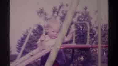 Gainsville Florida USA (1974): The Little Boy Is Playing With The Slide That He