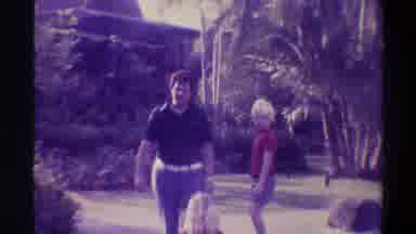 Gainsville Florida USA (1974): Two Kids And A Man Interacting In The Garden