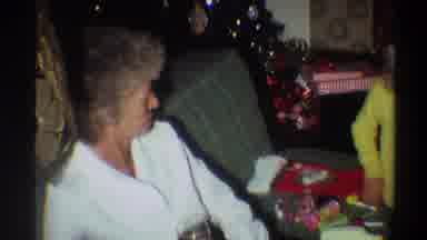 Gainsville Florida USA (1975): Lady In White Drinking And Looking At Child Who Is