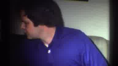 Gainsville Florida USA (1975): Men Smiling While A Child Opens A Present