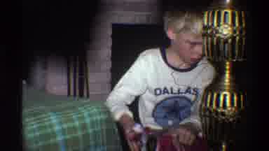 Gainsville Florida USA (1975): Boy In White T-Shirt Too Rushed To See His Gift And