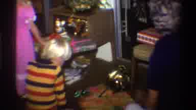 Gainsville Florida USA-1975: Family Opening Christmas Presents In Living Room