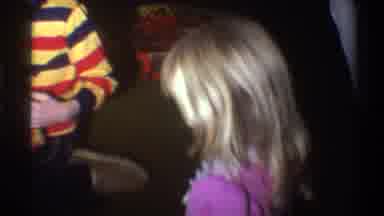 Gainsville Florida USA (1975): Two Children Open Presents While Adults Watch In