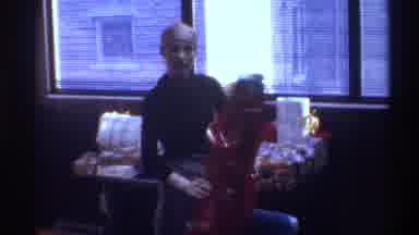 Gainsville Florida USA (1975): A Woman Wearing A Headscarf Opens Presents In Front