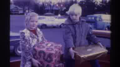 Gainsville Florida USA (1975): A Boy And A Girl Putting Down Presents In The Back