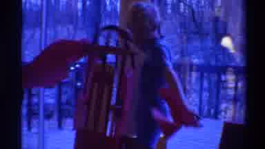 Gainsville Florida USA-1975: A Small Boy Tearing Open Gift Wrap On Balcony