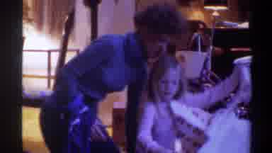 Gainsville Florida USA (1975): Woman Blue Turtleneck Young Blond Girl Unwrapping A