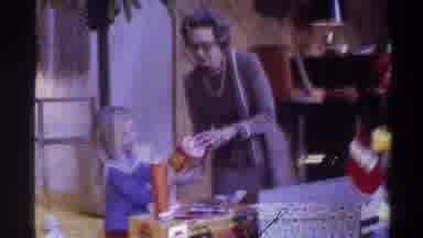 Gainsville Florida USA (1975): Little Girl Receiving New Toy From Parent At