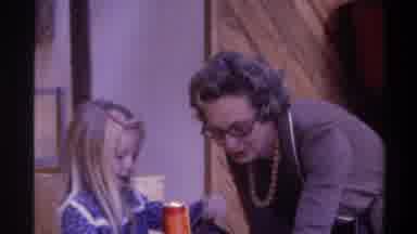 Gainsville Florida USA (1975): Girl Wearing Blue Looks At Doll With Woman Wearing