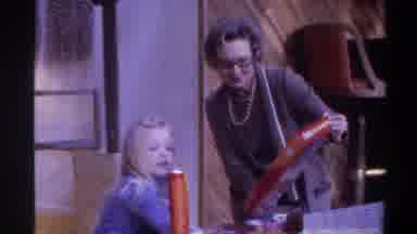 Gainsville Florida USA (1975): An Old Woman Trying To Show A Box To Small Child