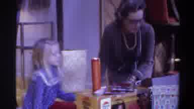 Gainsville Florida USA (1975): A Women And A Kid Picking One Of The Gift Box To