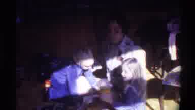 Gainsville Florida USA (1975): Two Kids Are Sitting Beside Her Mother And Looking