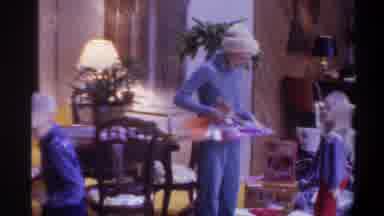 Gainsville Florida USA (1975): Children And Mother Wearing Blue Unwrap Christmas
