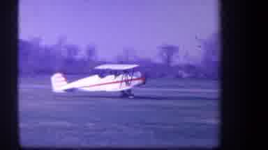 Volmer Yucaipa California USA (1959): Red And White Airplane Taking Off In A Field
