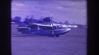 VOLMER YUCAIPA CALIFORNIA USA-1963: Small Amphibious Airplane Taxiing On Grass Airfield