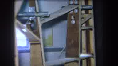 Volmer Yucaipa California USA-1964: Cluttered Storage Room With Wooden Shelves And Metal Brackets