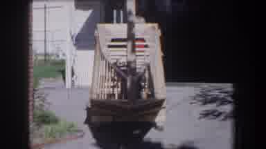 Volmer Yucaipa California USA (1965): Boy Playing Wood Toy Near House Outside