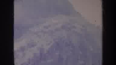 Honolulu Hawaii USA (1967): Panning View Of Snowy Mountain Base And Peak With Fog