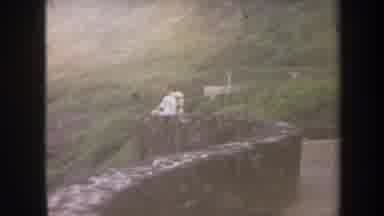 HONOLULU HAWAII USA-1967: Person on Stone Wall and Beachgoers
