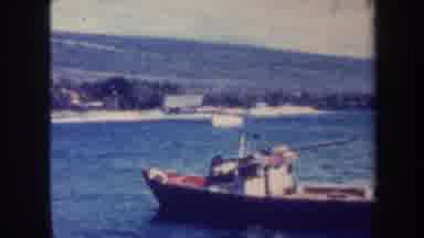 Honolulu Hawaii USA (1967): Small Boat Bobs In Calm Waters Off A Rural Countryside