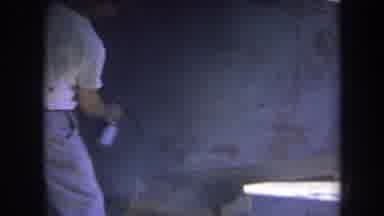 Volmer Yucaipa California USA (1969): A Man Sprays Down A Piece Of Wood