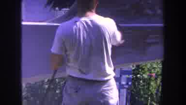 Volmer Yucaipa California USA (1969): A Man Using White Paint To Spray The Side Of