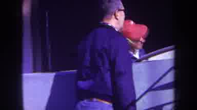 Volmer Yucaipa California USA (1969): 2 Peoples Fixing Something