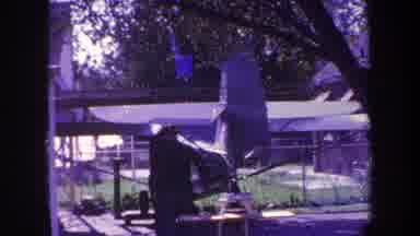 Volmer Yucaipa California USA (1969): A Person In A Garden Under A Tree Making A