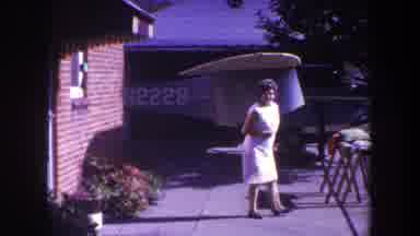 Volmer Yucaipa California USA (1969): Woman Walking On Sidewalk In Front Of Brick