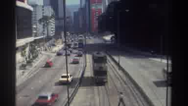 Hong Kong-1982: Busy Urban Street With Tram And Classic Cars