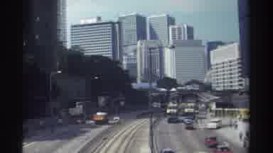 Hong Kong (1982): Many Vehicles Are Driving In And Out Of A Big City