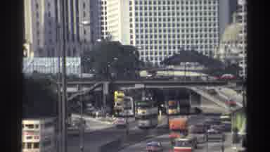 Hong Kong (1982): Busy Asian Urban Streets With Cars And Buses Traveling At High