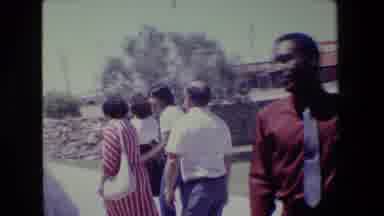Lansing Michigan (1983): People Are Walking By In Background And Another Person