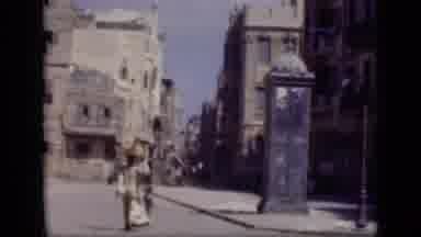 Cairo Egypt-1946: Woman And Child Walk Street With Blue Phone Booth, Men On Seaside Promenade