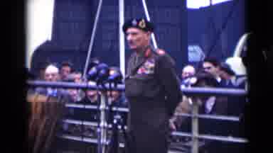 London England (1946): Military Man Standing Stoic And Speaking With A Crowd Of