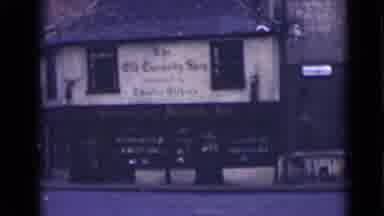 London England (1946): A Car Passes A Shop With A Large Glass Window Situated In