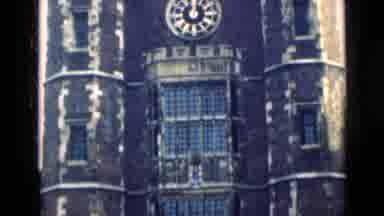 London England (1946): Gothic Church With Large Clock At 12:00 And A Street Scene